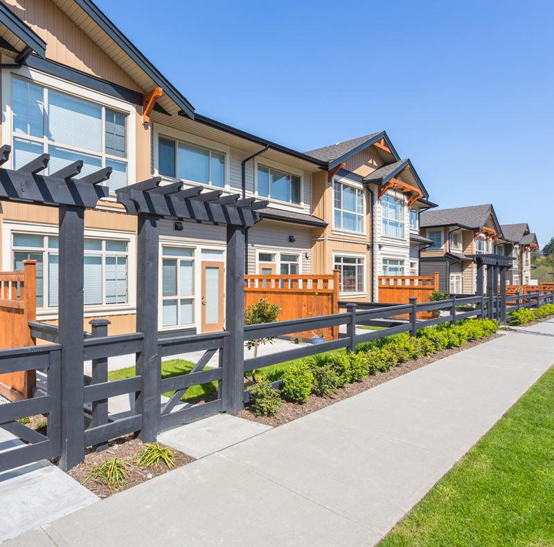 A row of coontemporary town homes in a walkable green community.